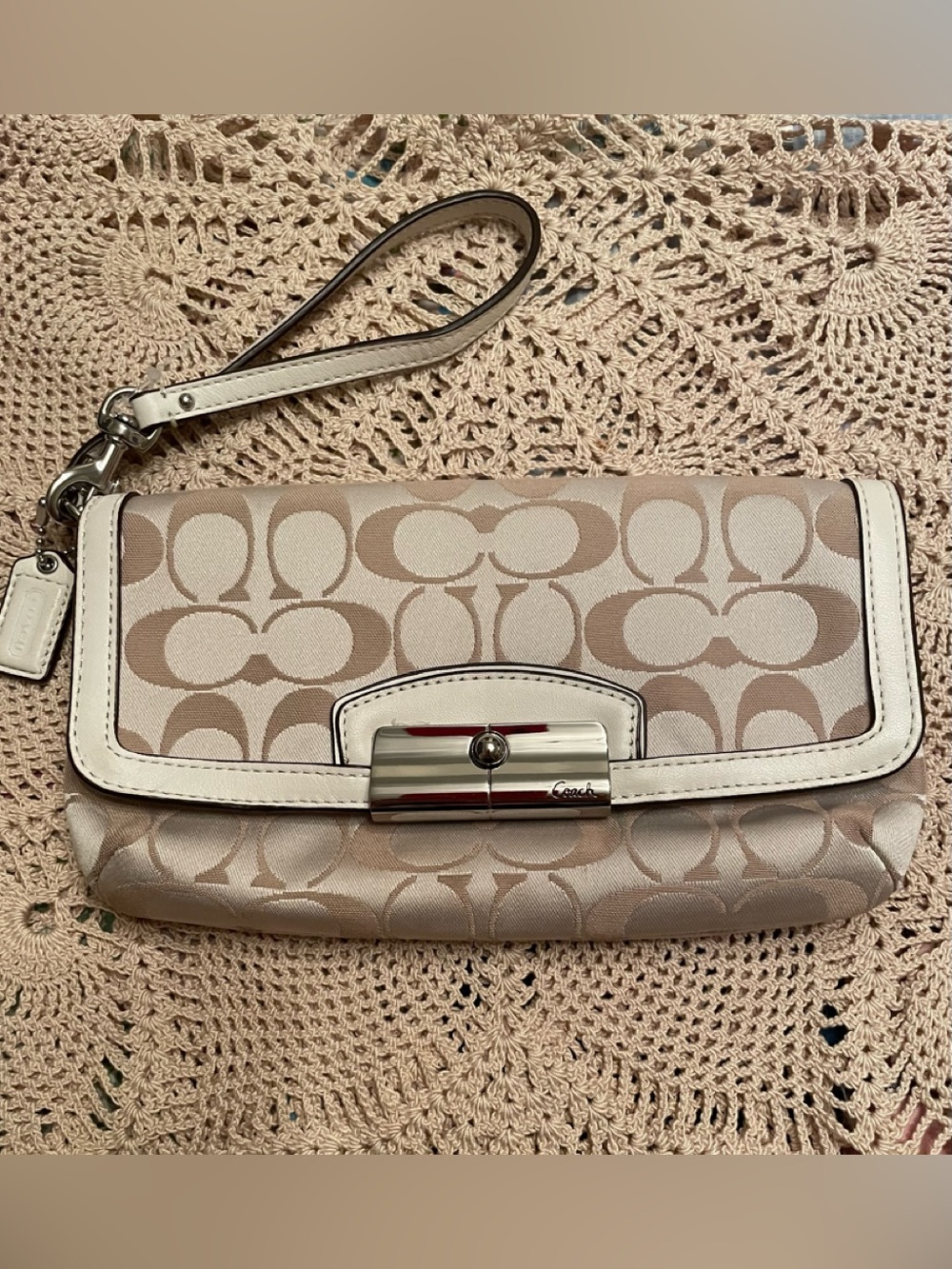 Coach wristlet features signature C pattern silver metal hardware closure
